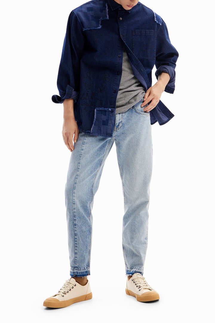 Denim shirt with embroidery and patches.