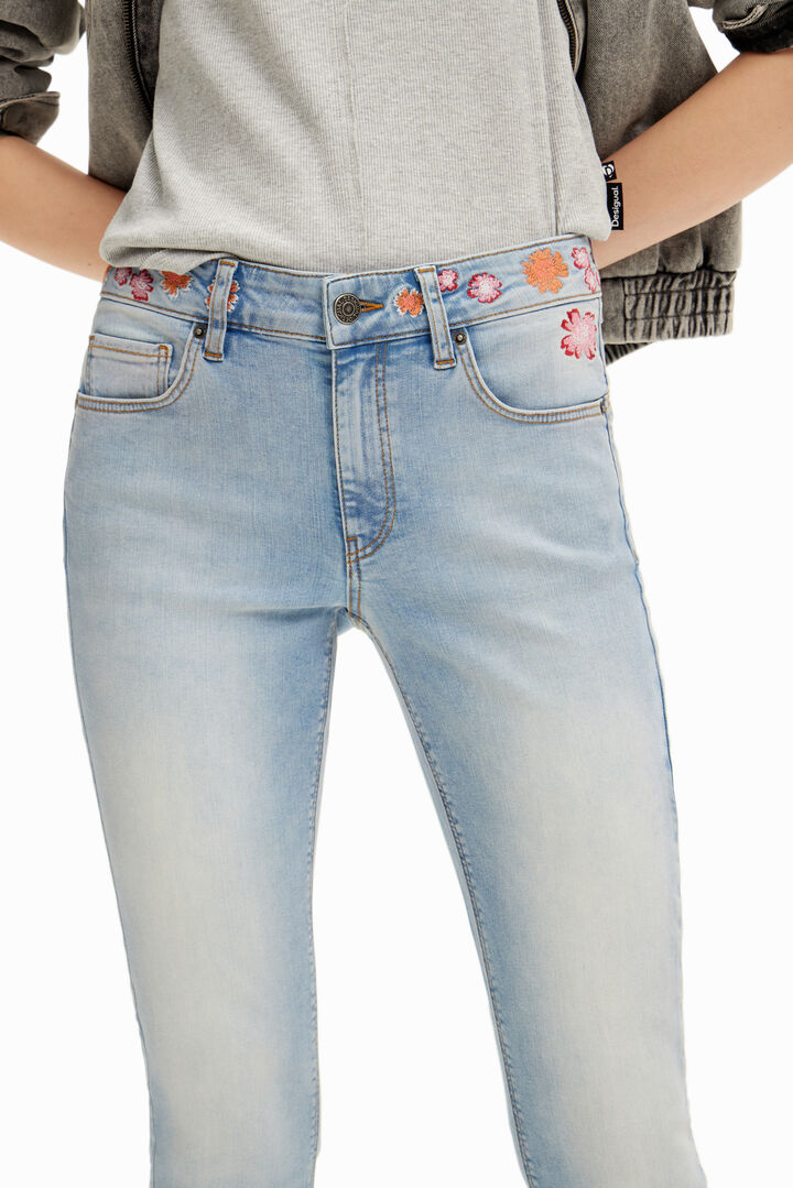 Long denim pants with flowers on the waist. | Desigual