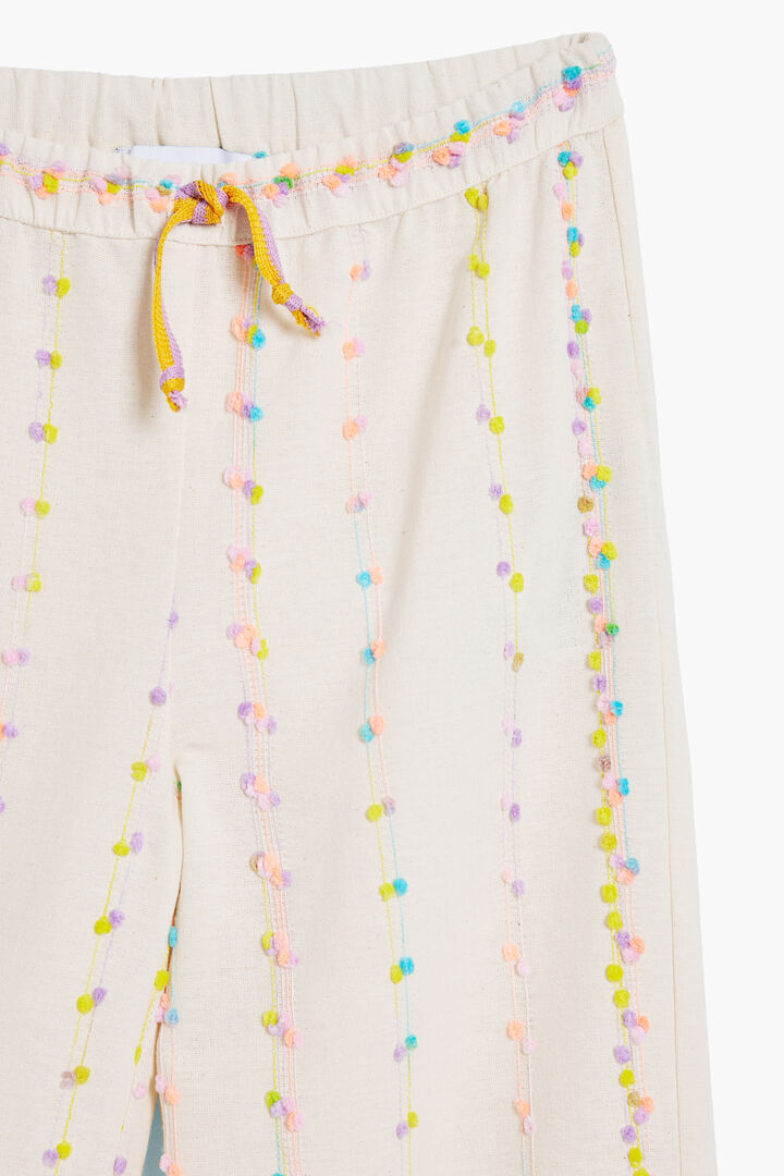 Long pants with pom-poms | Desigual