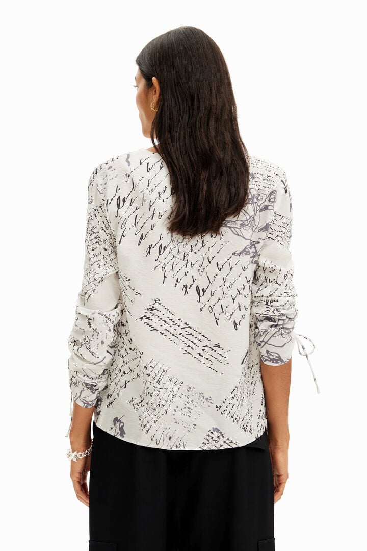 Blouse with adjustable sleeves and text prints. | Desigual
