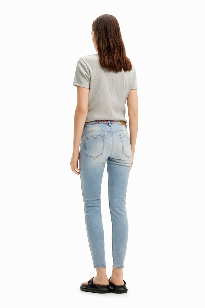 Long denim pants with flowers on the waist. | Desigual