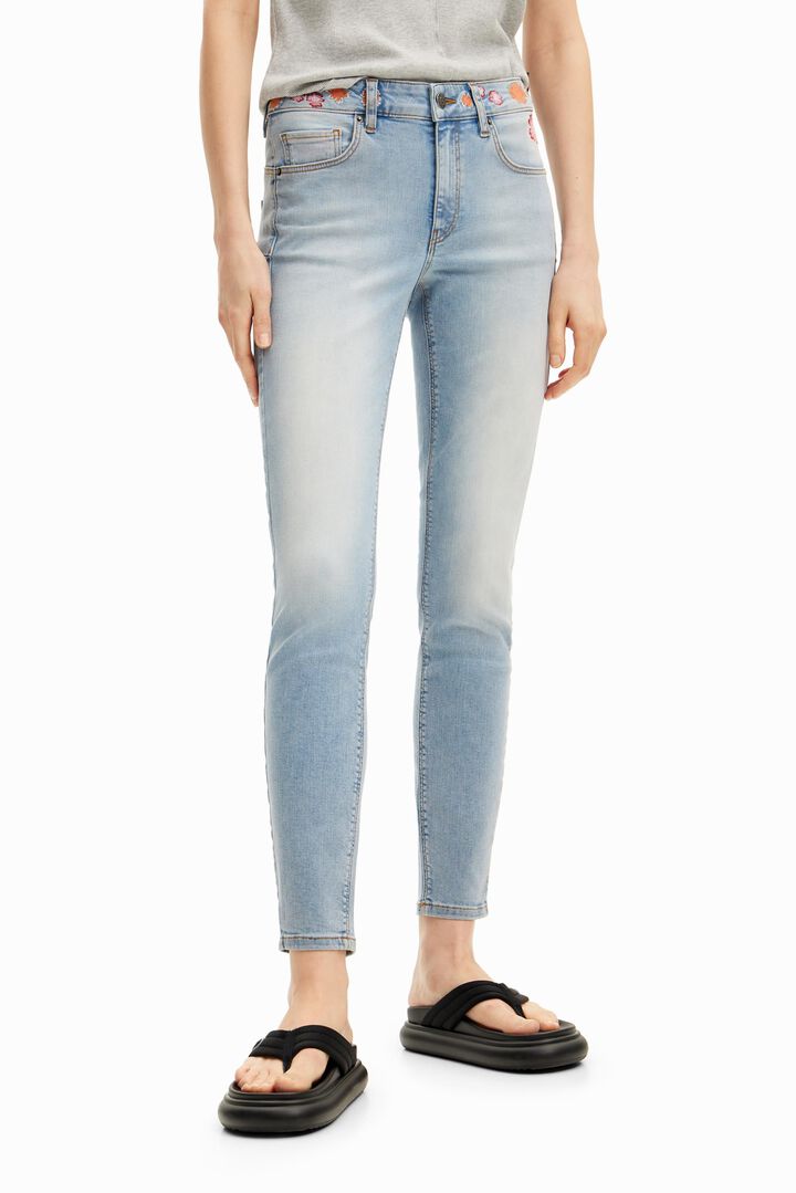 Long denim pants with flowers on the waist. | Desigual