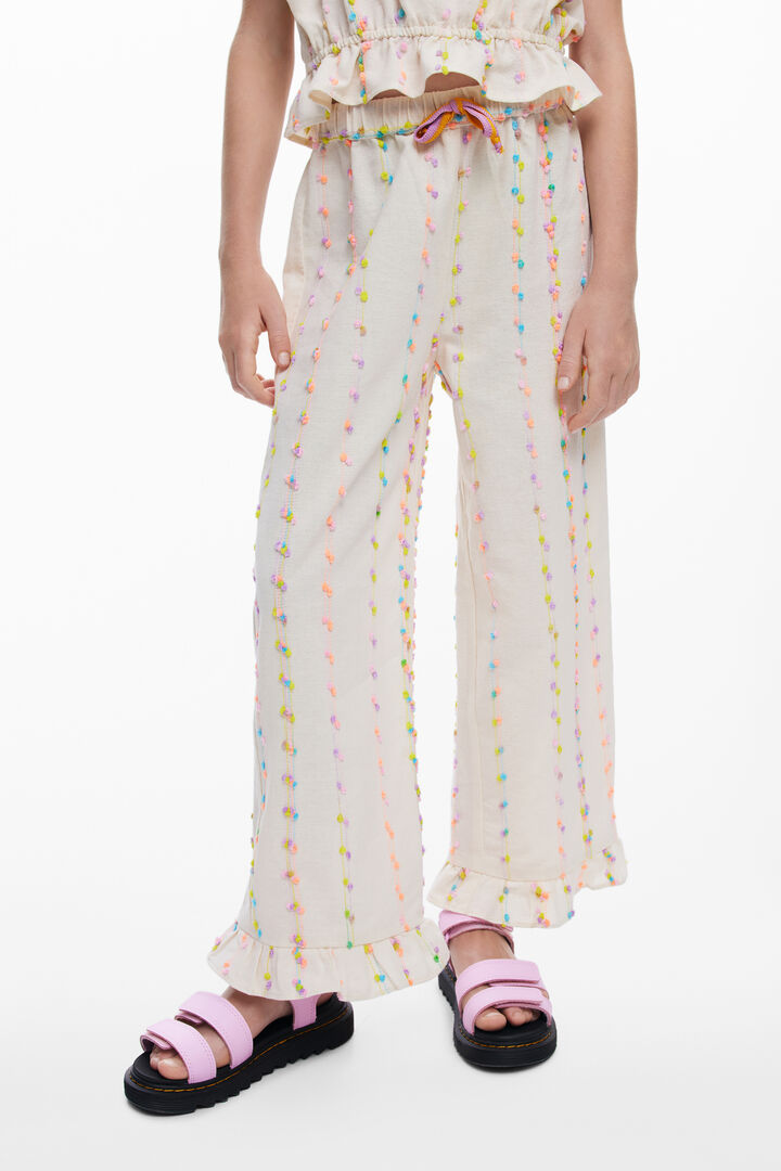 Long pants with pom-poms